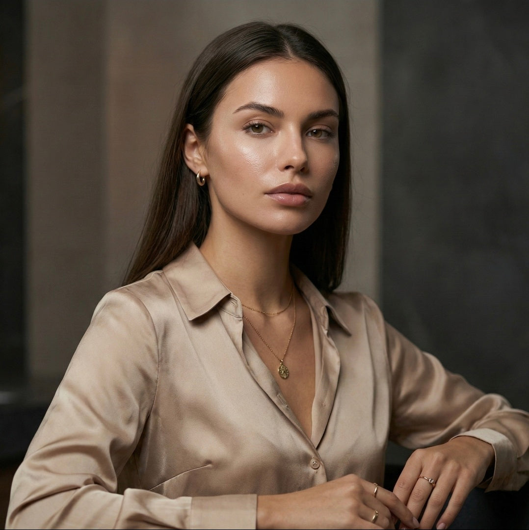 Woman wearing a beige shirt with a neutral background